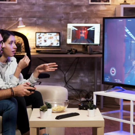 A vibrant montage of popular PS Plus games displayed across PlayStation 5 and PlayStation Plus tier interfaces.